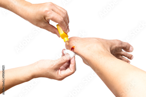 Nurse cleans a wound with an iodine isolated clipping path