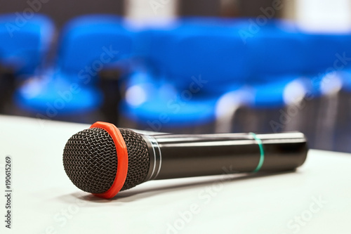 Black microphone on the table in empty auditorium