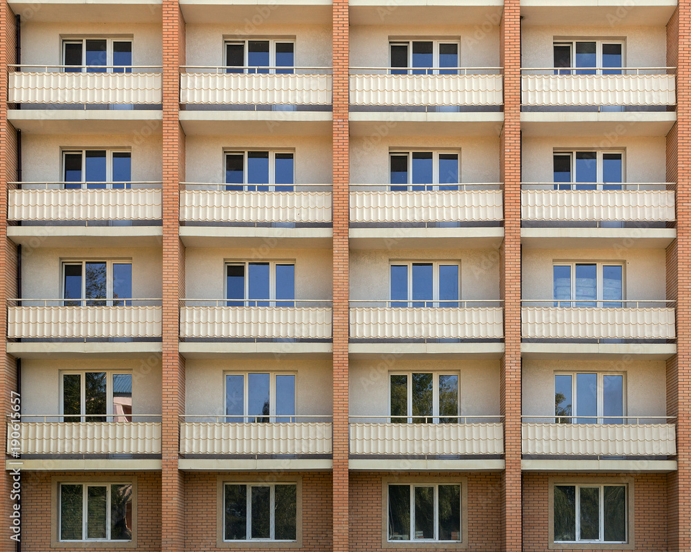 Facade of a house residential building windows with white wooden sash