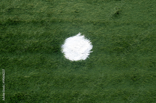 Soccer field with artificial grass pattern of penalty kick spot photo