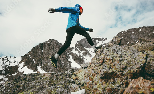 Travel Man running in mountains adventure lifestyle endurance concept active vacations skyrunning sport