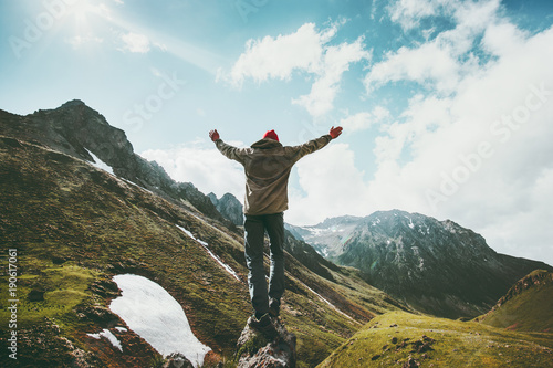 Photos Traveler Man raised hands standing on cliff mountains adventure travel lifestyle
