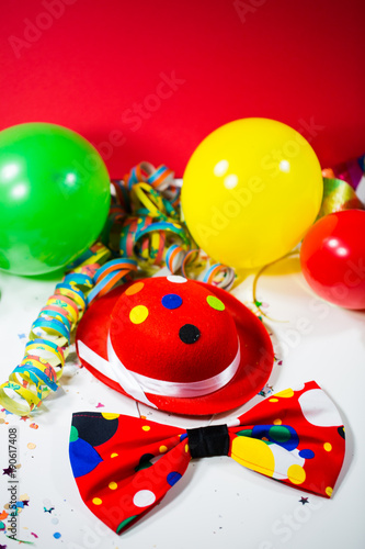 Party hat with bow, balloons and streamers