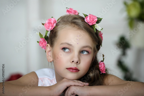 little girl with flowers in her hair portrait photo