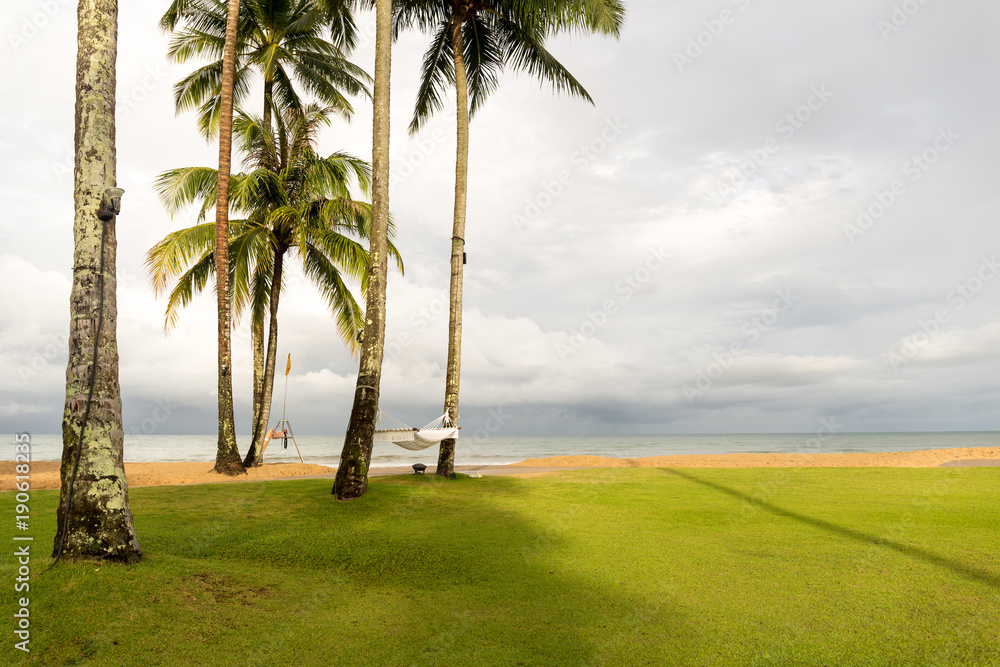 Fototapeta premium Hammock hanging between coconut trees on the beach