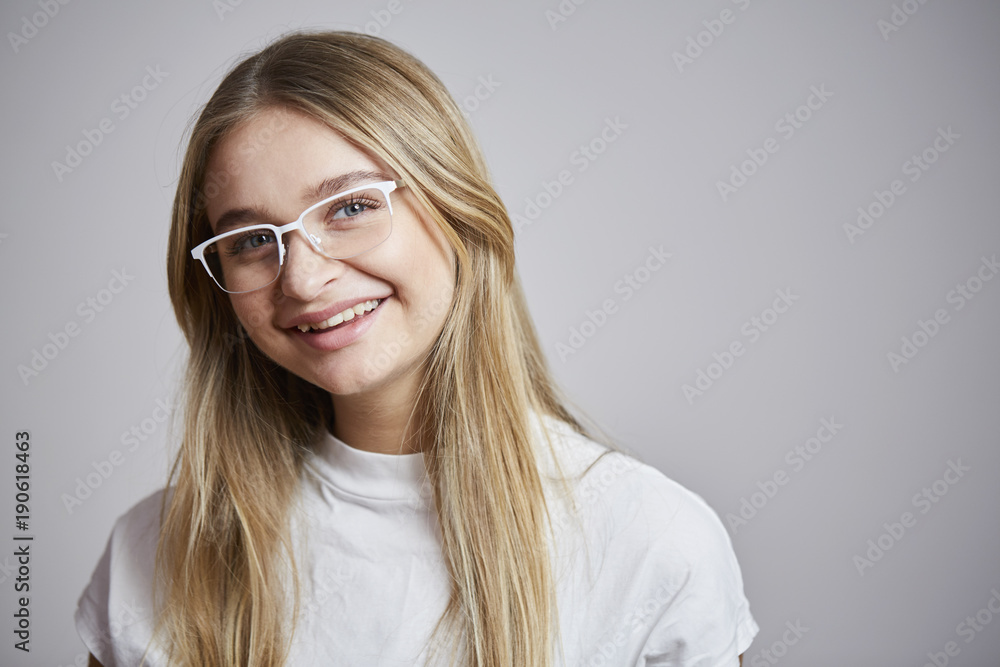 White glasses girl smiling to camera, studio White glasses girl smiling to camera, studio