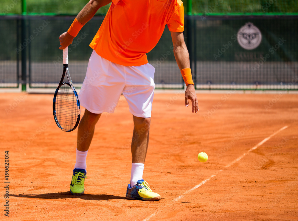 A man is playing tennis on the court
