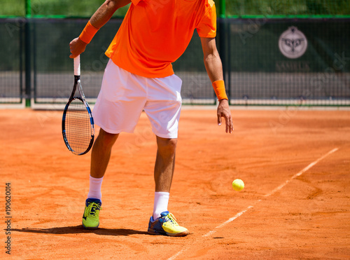 A man is playing tennis on the court