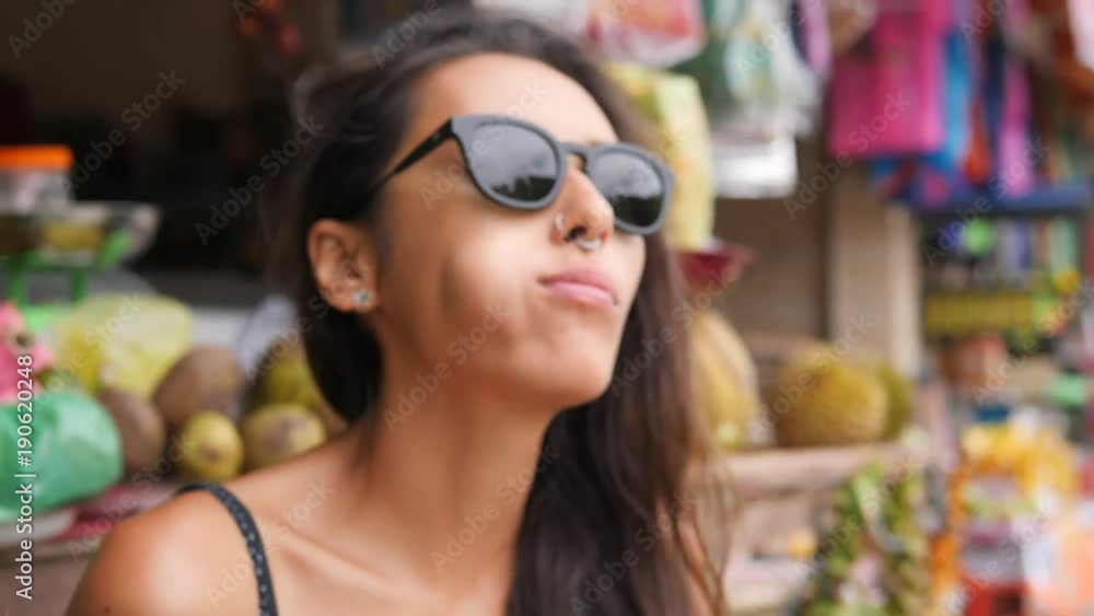 Attractive Tourist Woman Trying and Eating Exotic Durian Fruit. 4K, Bali, Indonesia. Attractive Tourist Woman Trying and Eating Exotic Durian Fruit. 4K, Bali, Indonesia.