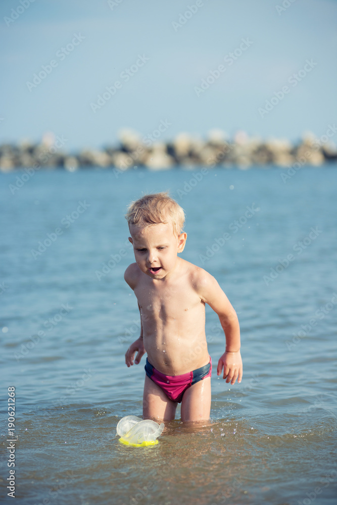 Little boy with snorkel by the sea. Cute little kid wearing mask and flippers for diving at sand tropical beach. Ocean coast. Little boy with snorkel by the sea. Cute little kid wearing mask and flippers for diving at sand tropical beach. Ocean coast.