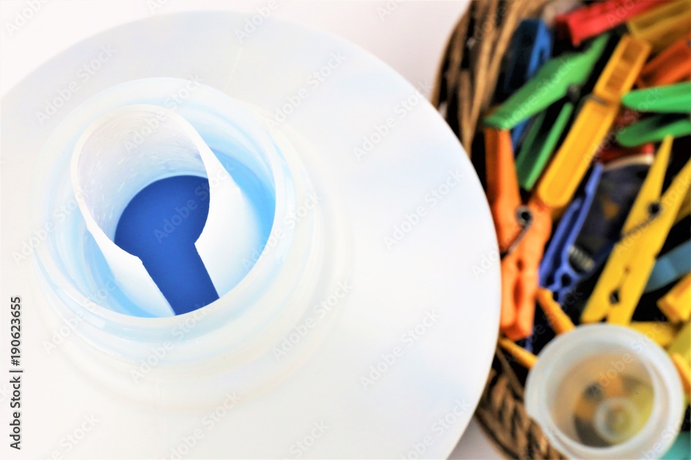 An concept Image of some colorful clothespins with liquid detergent An concept Image of some colorful clothespins with liquid detergent