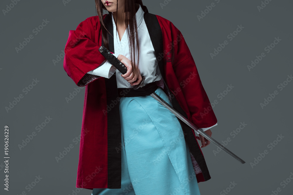 cropped shot of samurai in kimono holding katana sword isolated on grey  Photos | Adobe Stock