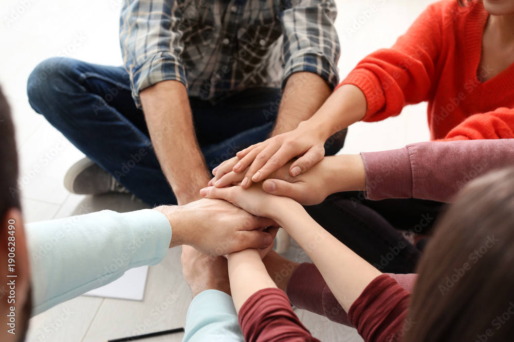 People putting hands together, closeup. Unity concept