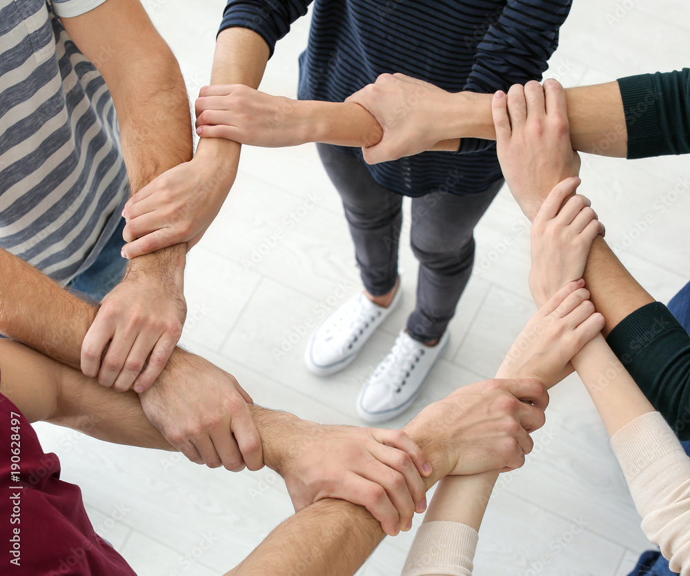 People holding hands together, closeup. Unity concept People holding hands together, closeup. Unity concept