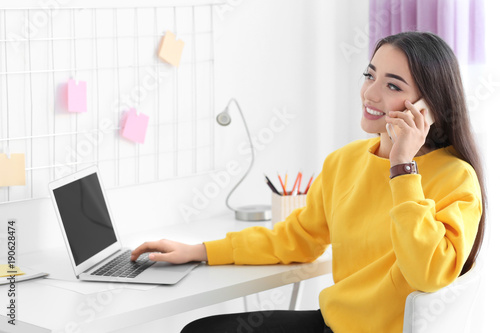 Young woman working in home...