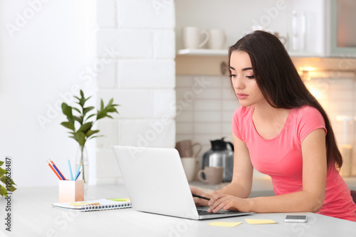 Young woman working in home...