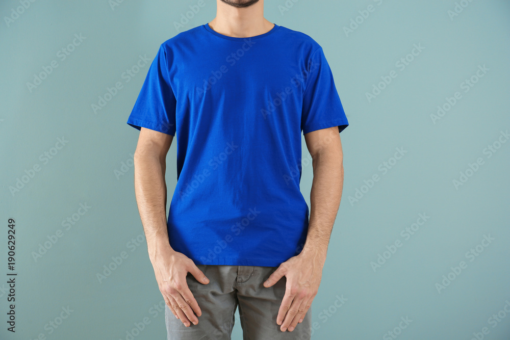 Young man in stylish t-shirt on color background. Mockup for design Young man in stylish t-shirt on color background. Mockup for design