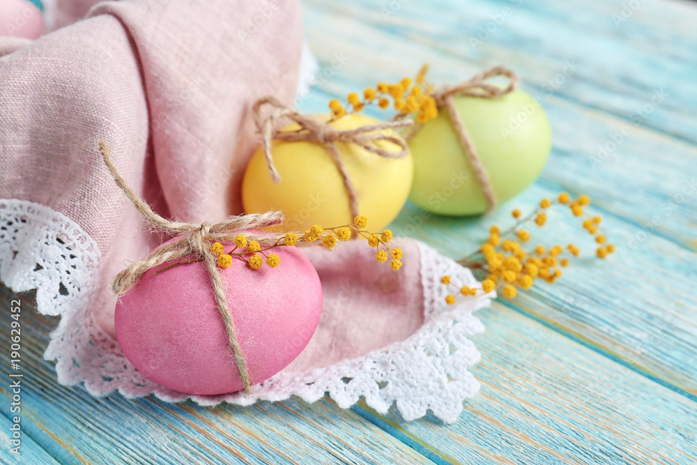 Easter eggs with mimosa flowers on table Easter eggs with mimosa flowers on table