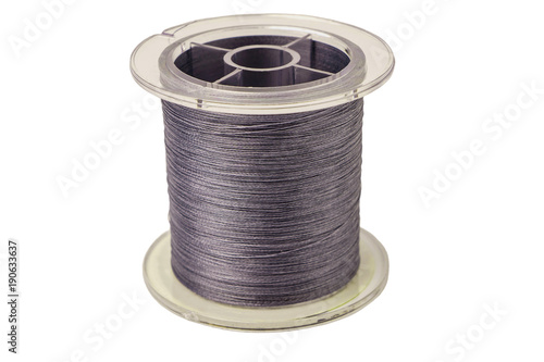 Spool of gray cord isolated on white background. Spool of braide photo