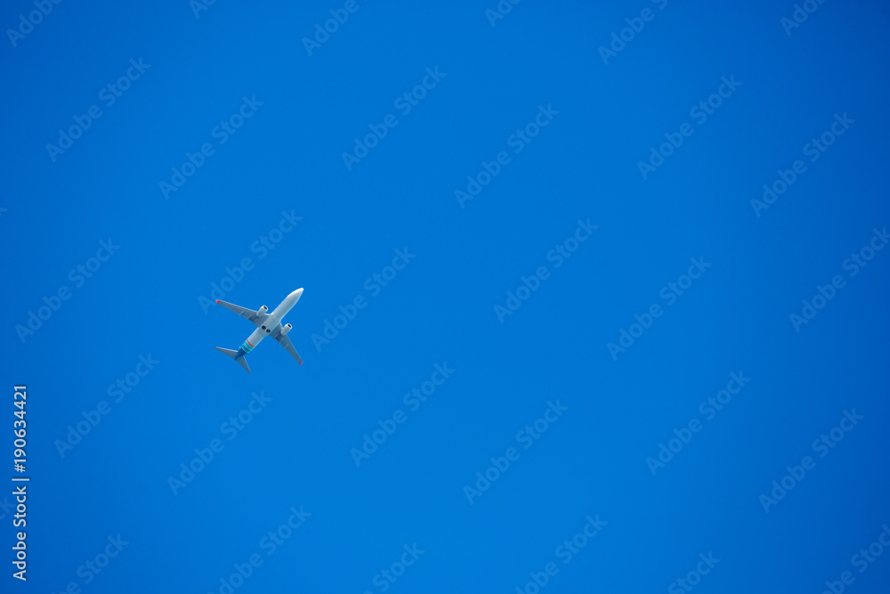 airplane on blue sky background, travel or vacation concept airplane on blue sky background, travel or vacation concept