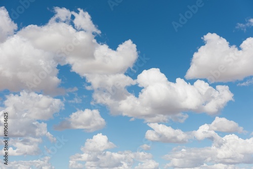 Cumulus clouds against blue sky photo
