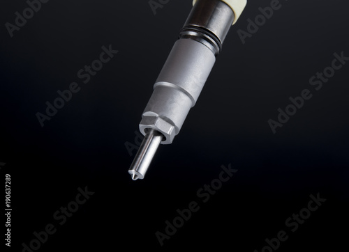 Buttom part of diesel fuel injector isolated on black