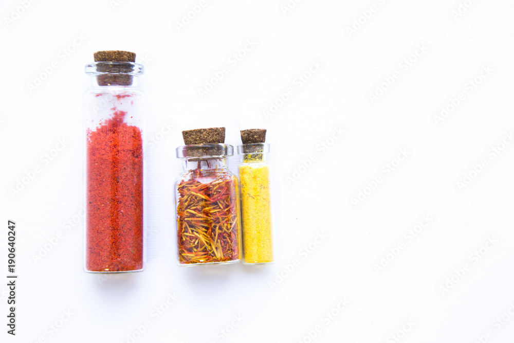 Set of spices and herbs in glass jars with corks isolated on white, copy space Set of spices and herbs in glass jars with corks isolated on white, copy space