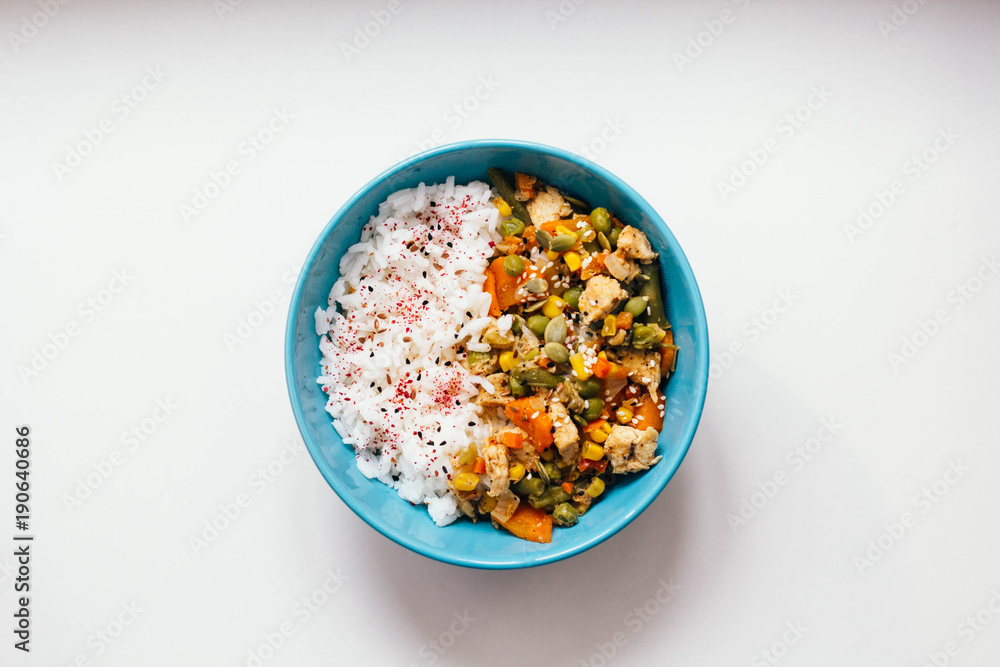 Rice with vegetables: carrots and corn, green beans, peas with pumpkin seeds and spices on white background. top view, close up, flat lay. vegetarian healthy or organic food concept. Rice with vegetables: carrots and corn, green beans, peas with pumpkin seeds and spices on white background. top view, close up, flat lay. vegetarian healthy or organic food concept.