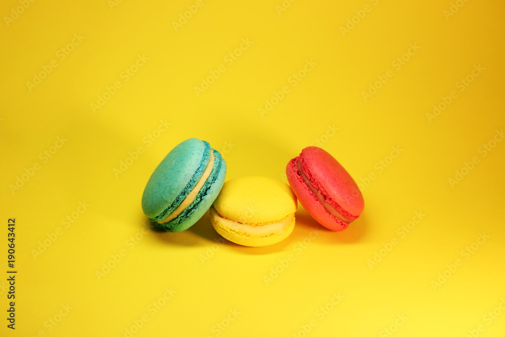 Bright food photography of macroons on yellow background Bright food photography of macroons on yellow background