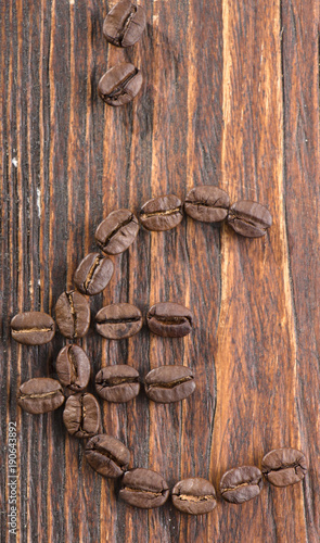 Sign of coffee seeds on a wooden background