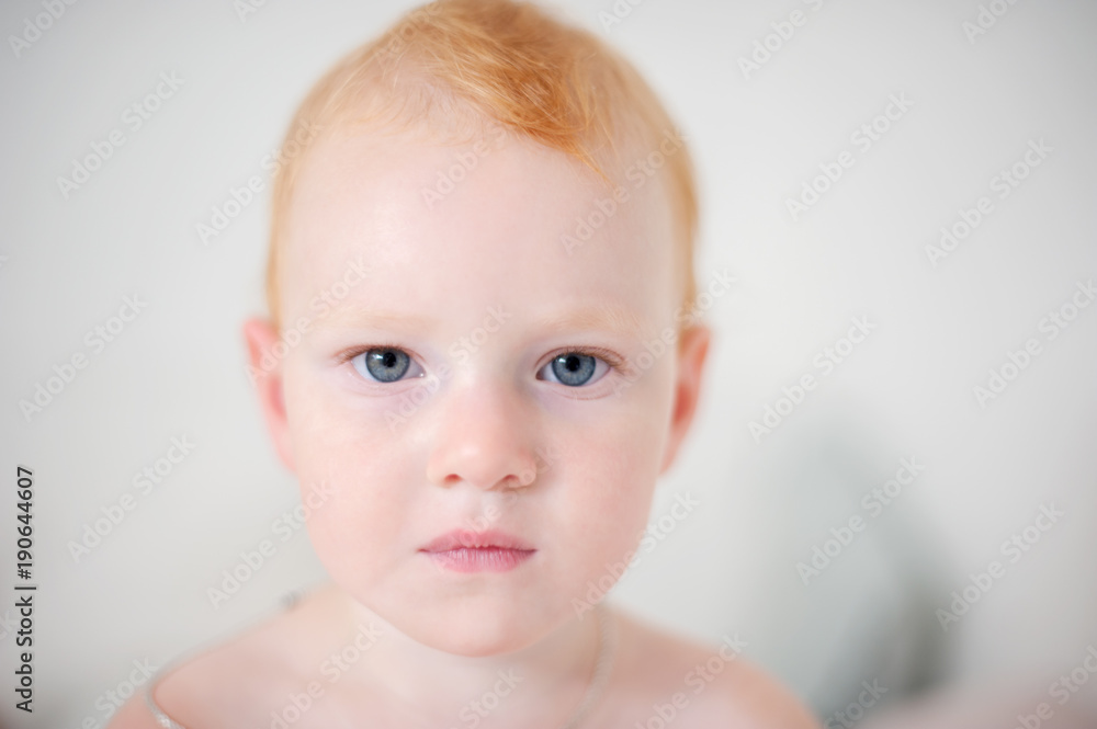 Portrait of a redheaded baby on the white background Portrait of a redheaded baby on the white background