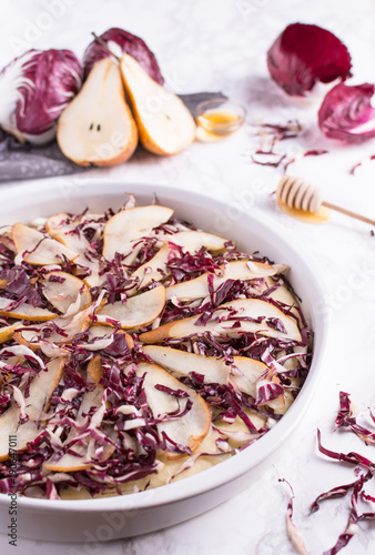 Focaccia with red radicchio, taleggio cheese and pears topped with a drizzle of honey. Traditional Italian recipe.