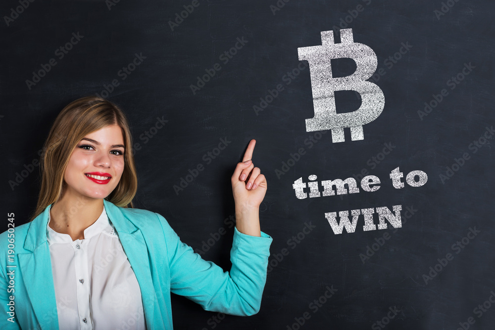 Beautiful young female points to bitcoin. Beautiful young female points to bitcoin.