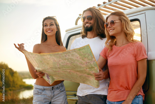 People Using Map Traveling In Summer.