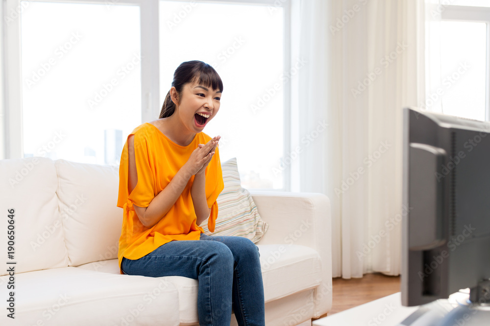 happy asian woman with watching tv at home happy asian woman with watching tv at home