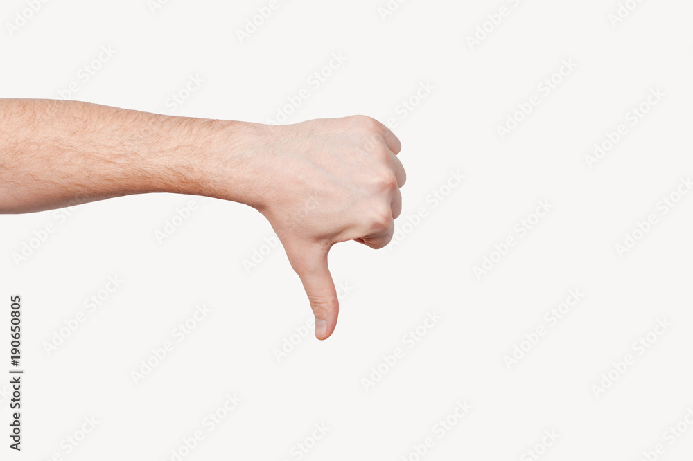 Closeup of male hand showing thumbs down sign against white background. Dislike Closeup of male hand showing thumbs down sign against white background. Dislike