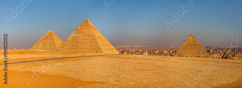 Three Pyramids of Cairo at sunset in Egypt