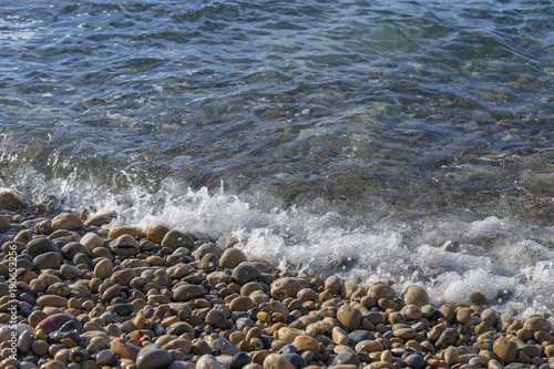 colored sea pebbles on a rocky beach close-up