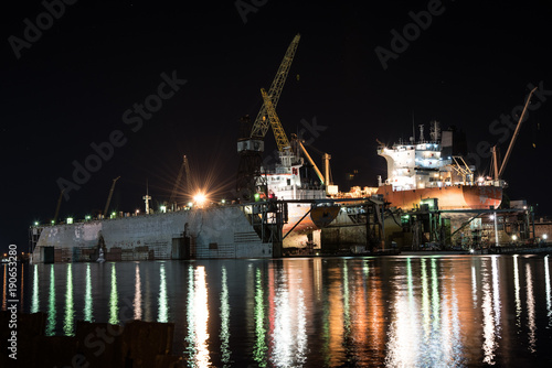 Large ships in shipyard at night