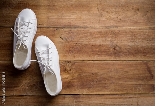 Couple of white shoe on wood background