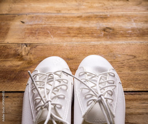 Couple of white shoe on wood background