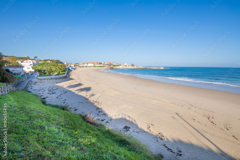 Landscape high shot view of Comillas Beach and Cantabrian Sea, with blue sky, in Cantabria, Spain, Europe
