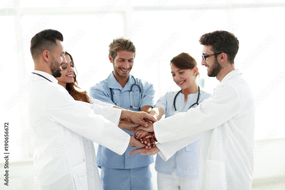Fototapeta premium Doctors and nurses stacking hands. concept of mutual aid.