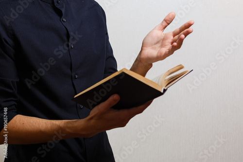 Pensive stylish man reading a book isolated over white background