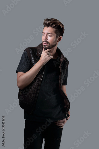 portrait of thinking stylish young man touch his beard