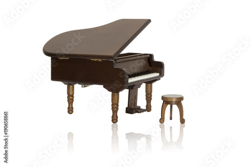 Model of wooden piano and its reflection isolated on white background with clipping path