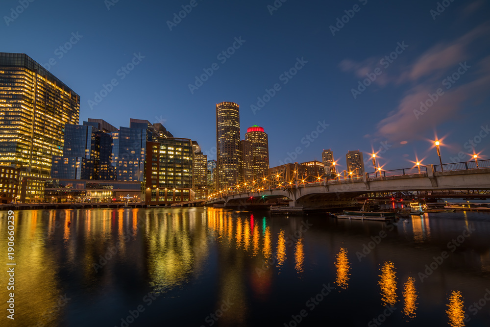 Night view of the city, skyscrapers in the lights, a bridge across the bay. Boston. USA.
