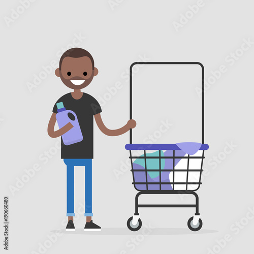 Daily routine. Young black character washing clothes in a public coin laundry. Flat editable vector illustration, clip art