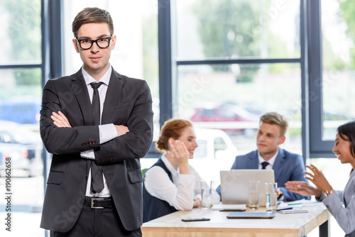 Wallpaper Mural Confident businessman in front of his colleagues in modern office Torontodigital.ca