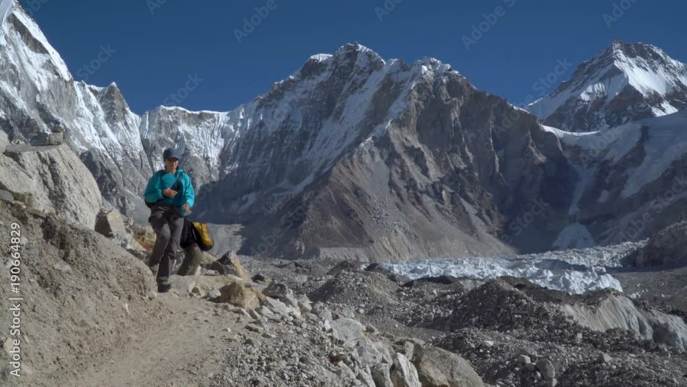Girls of the tourist go along the trail in the Himalayas. Beautiful view of the snow-capped mountain peaks Girls of the tourist go along the trail in the Himalayas. Beautiful view of the snow-capped mountain peaks